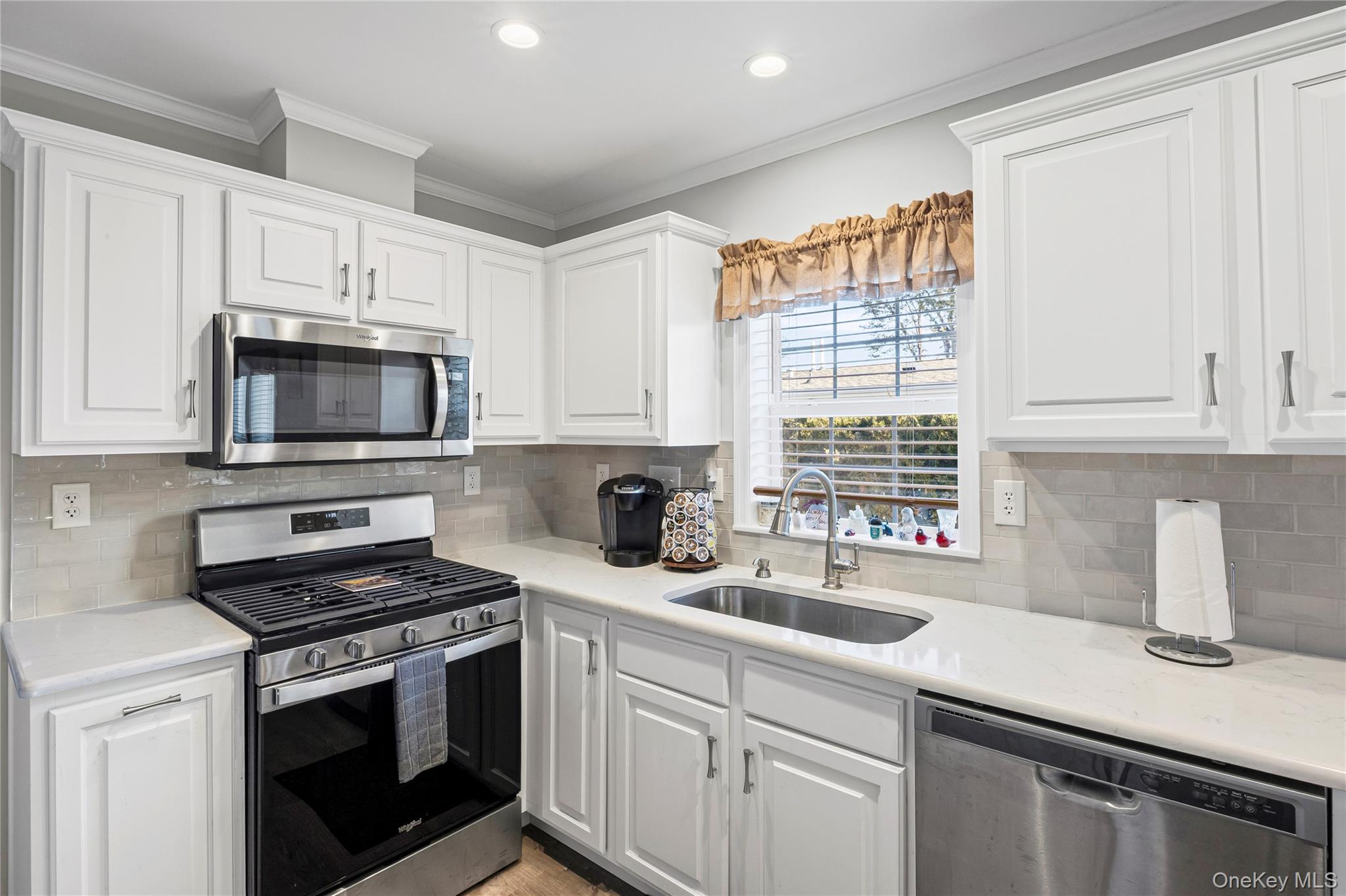 1661 Old Country Road, Unit 351B Riverhead, NY 11901 - Photo 5 of 32 a kitchen with appliances a sink and a window