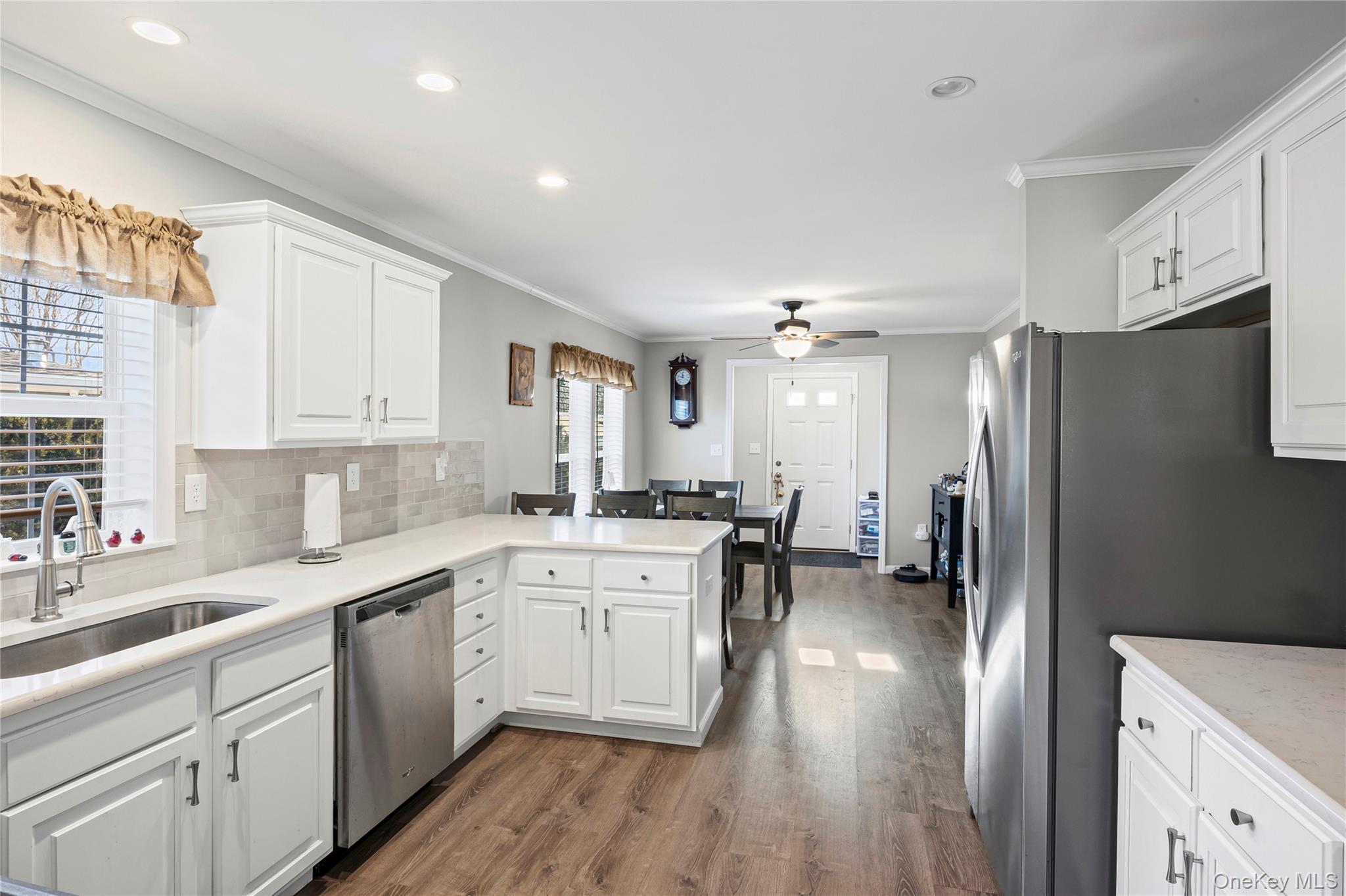 1661 Old Country Road, Unit 351B Riverhead, NY 11901 - Photo 6 of 32 a kitchen with a sink stainless steel appliances and cabinets
