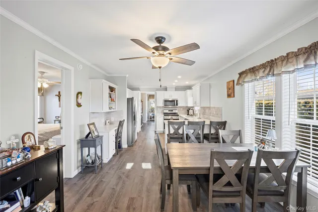 a view of a dining room with furniture and wooden floor