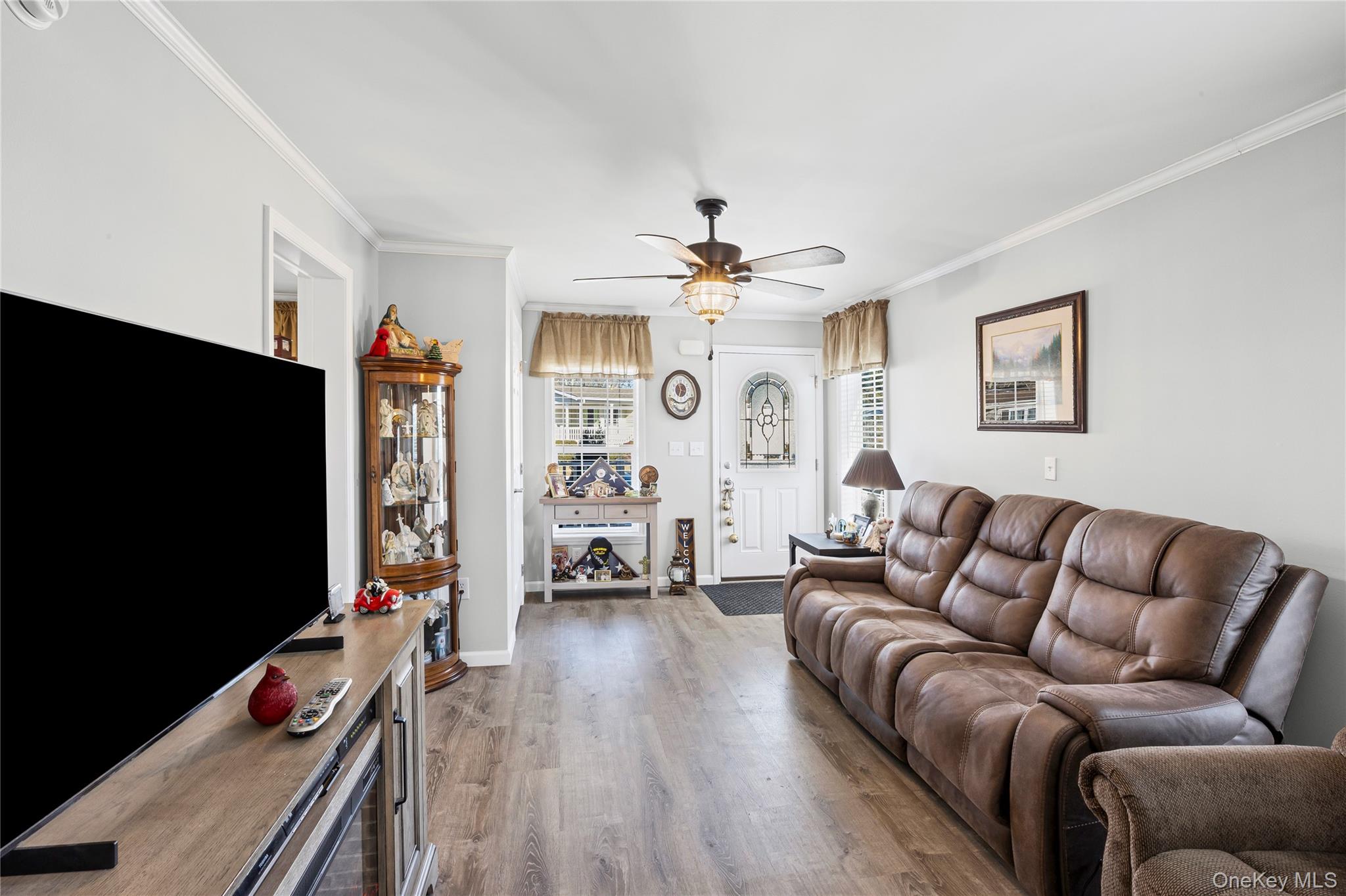 1661 Old Country Road, Unit 351B Riverhead, NY 11901 - Photo 10 of 32 a living room with furniture flat screen tv and a fireplace
