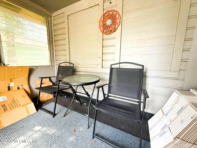a view of a yard with a house and a large tree