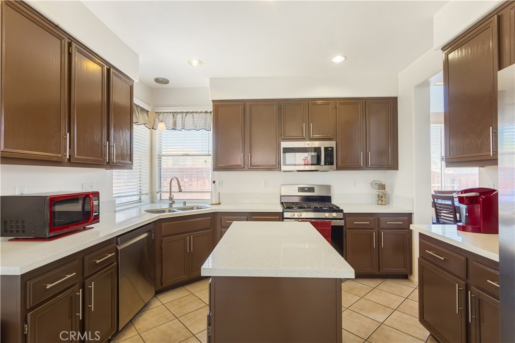 44655 Mill Run Temecula, CA 92592 - Photo 2 of 37 a kitchen with stainless steel appliances a sink stove refrigerator and cabinets