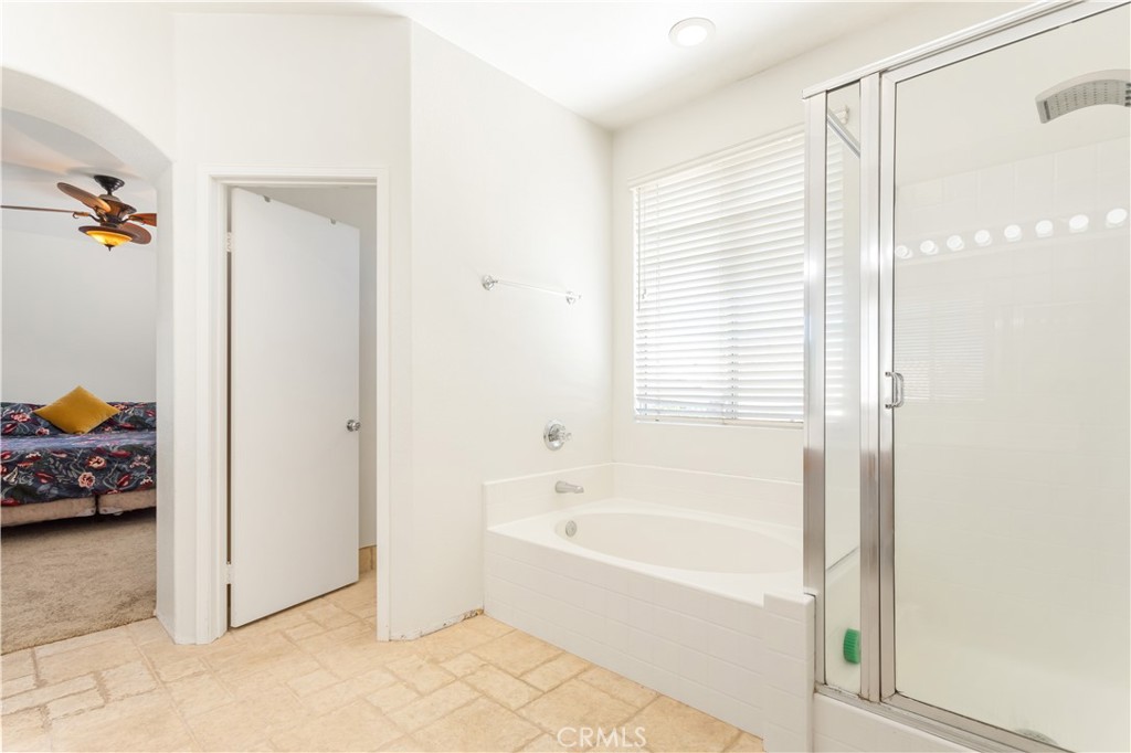 44655 Mill Run Temecula, CA 92592 - Photo 24 of 37 a bathroom with a tub and shower