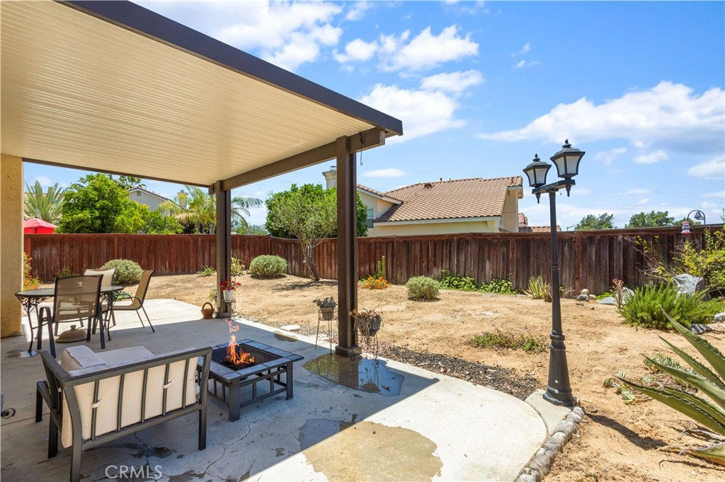 44655 Mill Run Temecula, CA 92592 - Photo 31 of 37 a view of a patio with a table chairs and wooden fence