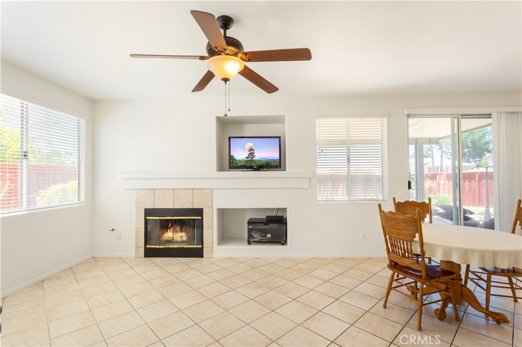 44655 Mill Run Temecula, CA 92592 - Photo 6 of 37 a living room with furniture a fireplace and a large window