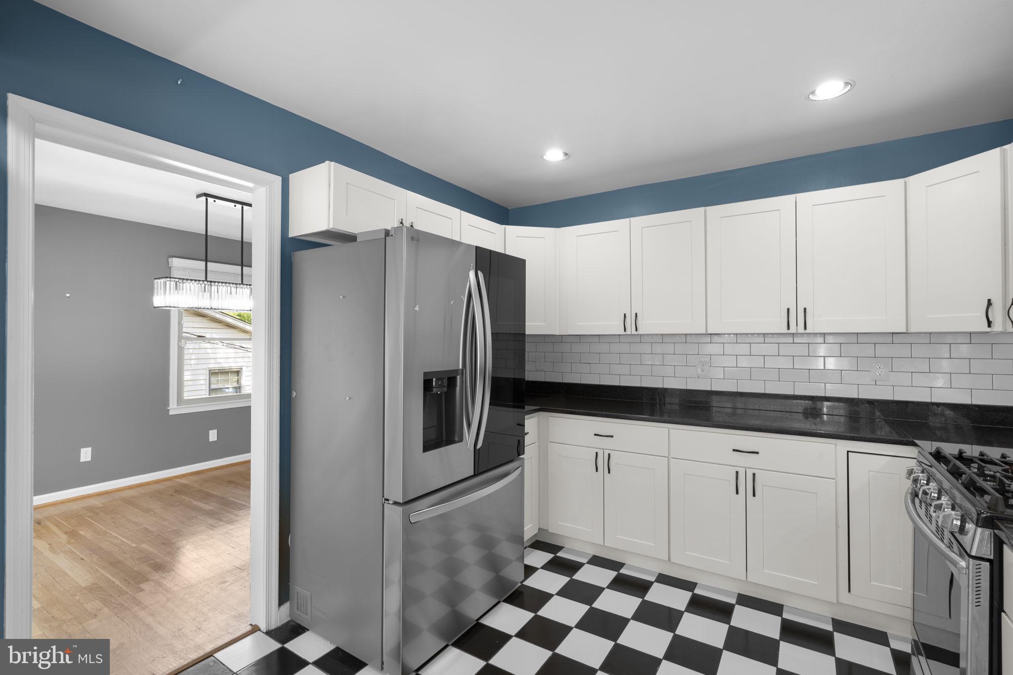 822 Loxford Terrace Silver Spring, MD 20901 - Photo 23 of 61 a kitchen with granite countertop a refrigerator and a sink