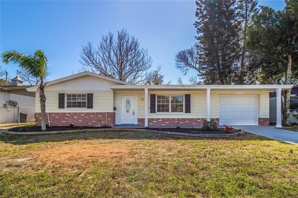 3824 Moog Road Holiday, FL 34691 - Photo 1 of 16 a view of house with yard outdoor seating and barbeque oven