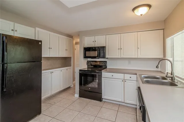 a kitchen with a sink appliances and cabinets