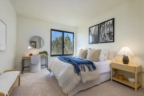 a bedroom with a bed and a desk