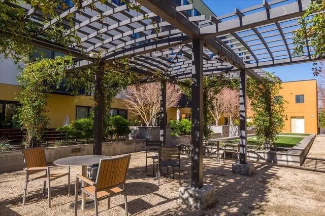 a patio with water view with outdoor seating