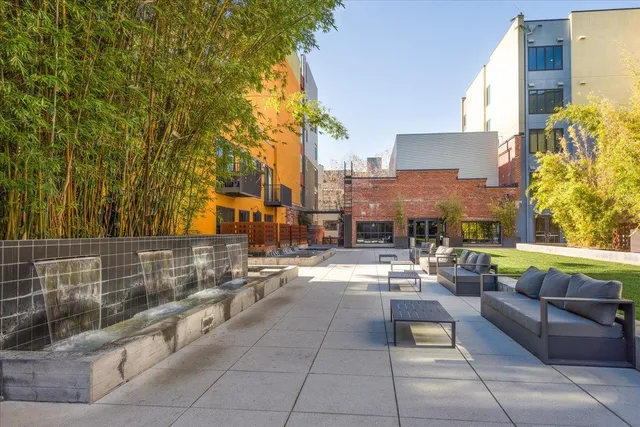 a view of a patio with couches and potted plants