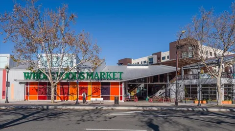 a view of large building with a big yard and large trees