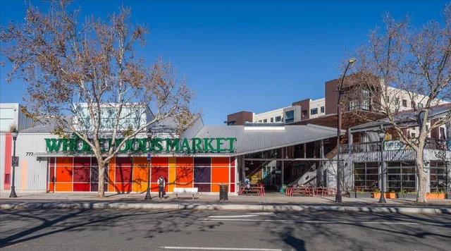 a view of large building with a big yard and large trees