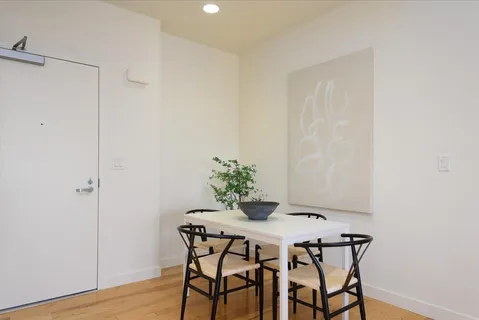 a dining room with furniture and wooden floor
