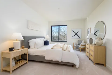 a bedroom with bed and a window
