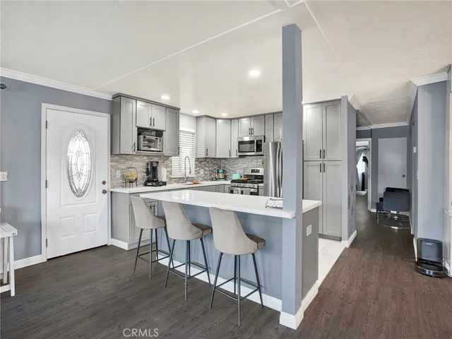 a kitchen with stainless steel appliances a refrigerator and a stove top oven
