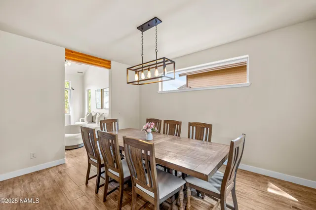 a view of a dining room a table and chairs