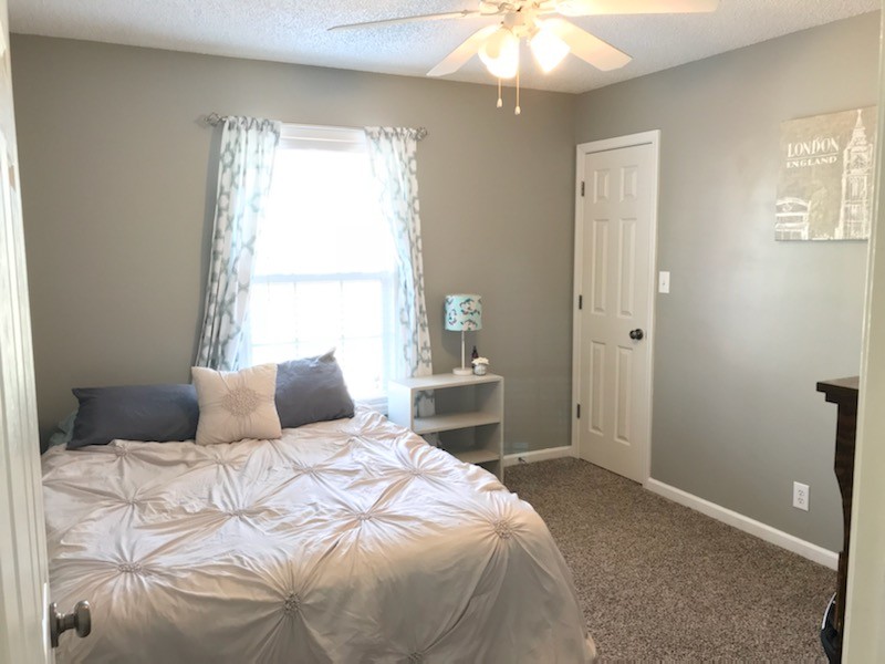 1740 Hazelwood Road Clarksville, TN 37040 - Photo 13 of 20 a bedroom with a bed and a chandelier