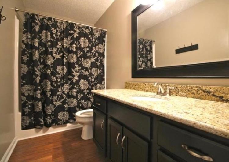 1740 Hazelwood Road Clarksville, TN 37040 - Photo 15 of 20 a bathroom with a granite countertop sink and a toilet