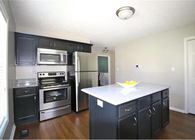 1740 Hazelwood Road Clarksville, TN 37040 - Photo 4 of 20 a kitchen with a refrigerator and a stove