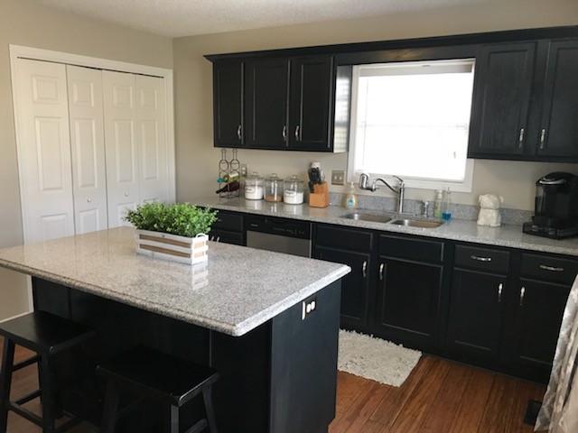1740 Hazelwood Road Clarksville, TN 37040 - Photo 6 of 20 a kitchen with a sink a stove and wooden cabinets