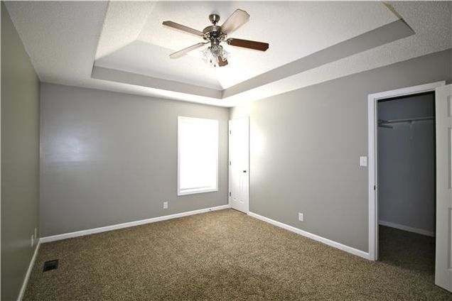 1740 Hazelwood Road Clarksville, TN 37040 - Photo 10 of 20 an empty room with windows and fan