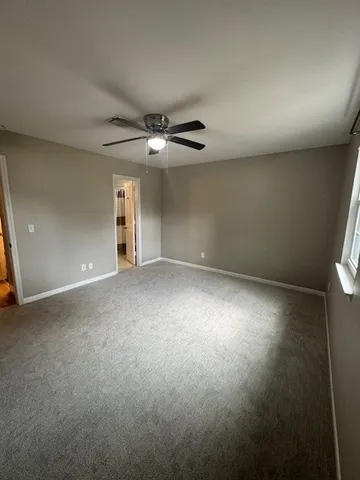 an empty room with a empty space and a ceiling fan