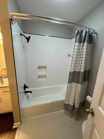 a bathroom with a shower and a bathtub