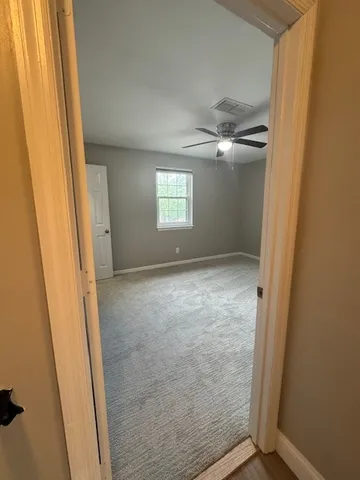an empty room with windows and closet