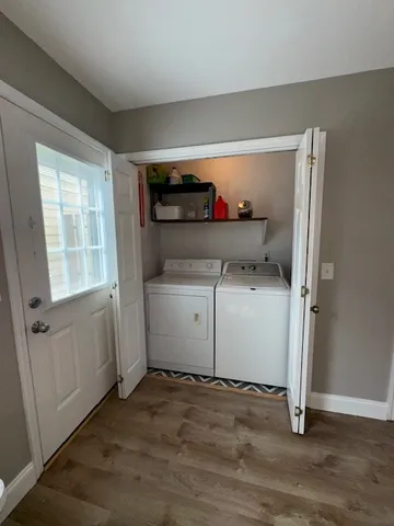 a utility room with cabinets washer and dryer