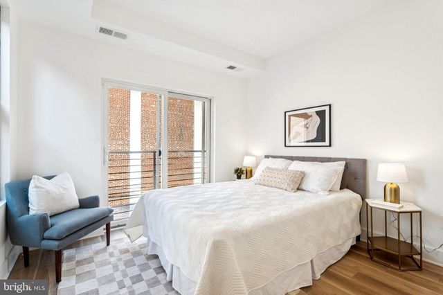 a bedroom with a bed and a couch