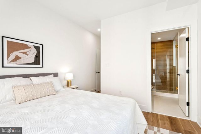 a bedroom with a bed and a painting on the wall