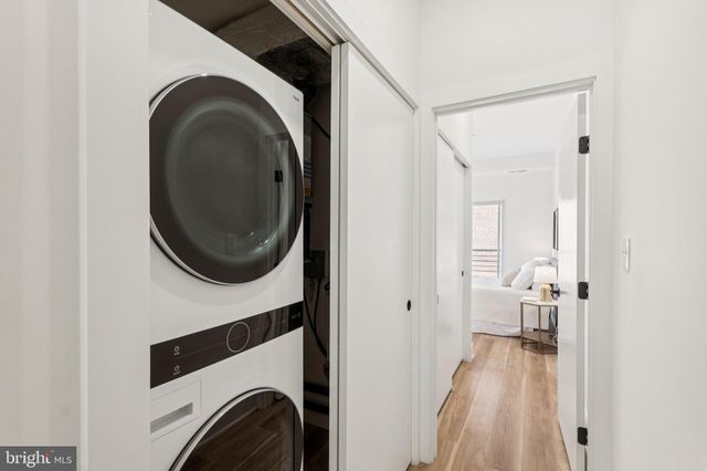a view of a hallway with washer and dryer