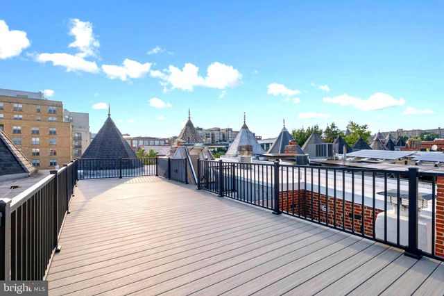 a view of a roof deck with wooden floor and fence