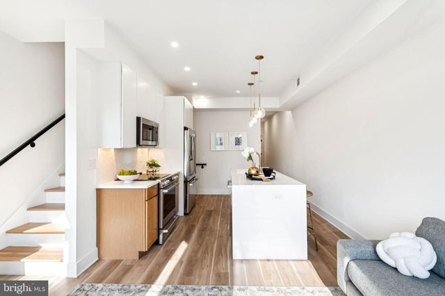 a kitchen with a sink a stove and a refrigerator