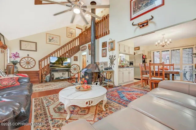 a living room with patio furniture and a rug