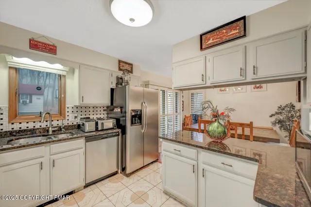 a kitchen with cabinets a sink and appliances