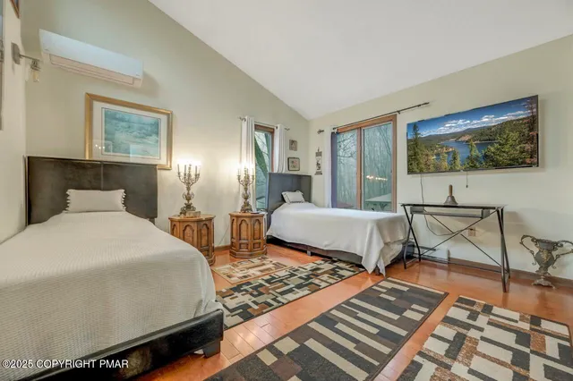 a bedroom with a bed and glass windows