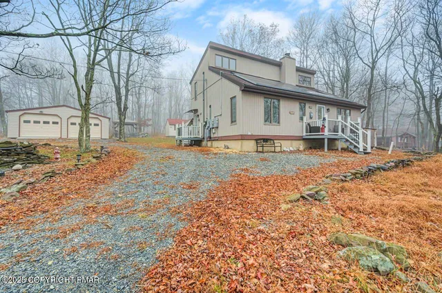 a front view of a house with a yard covered in snow