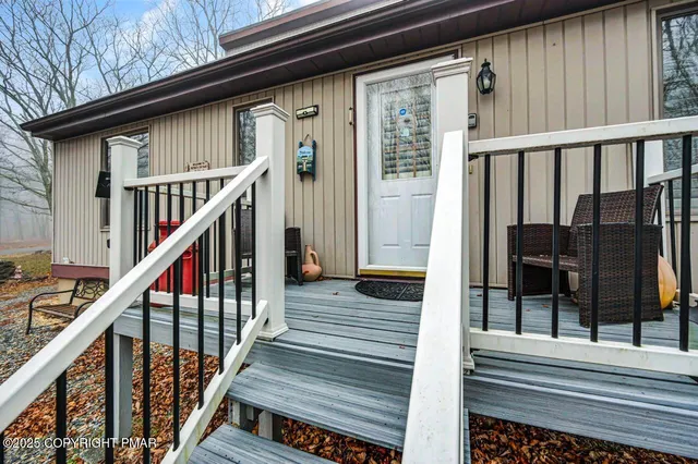 a view of a balcony with wooden floor and stairs