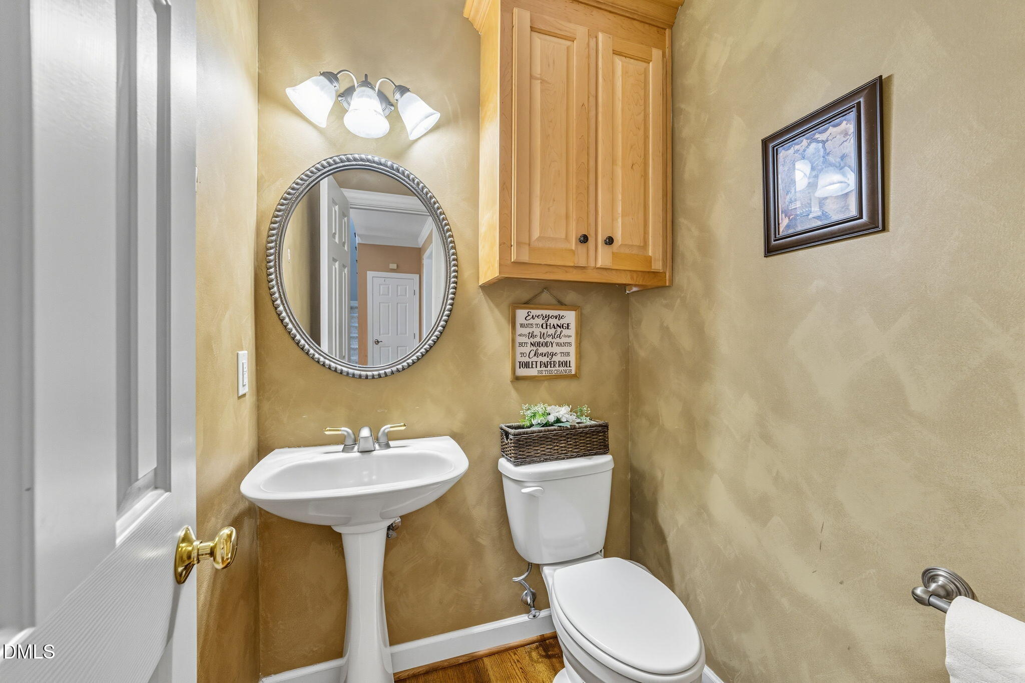 1617 Kendall Hill Road Willow Spring, NC 27592 - Photo 40 of 58 a bathroom with a toilet sink and mirror