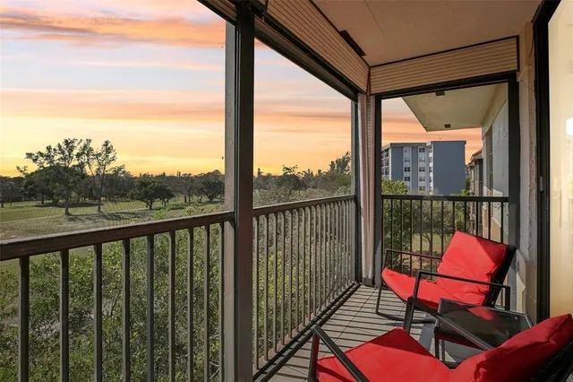 a view of a city from a balcony with furniture