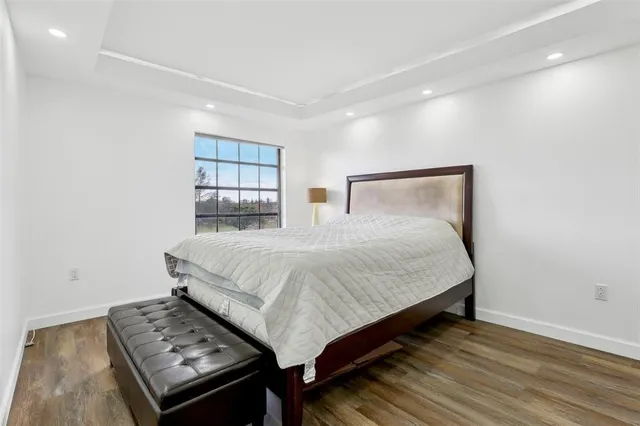 a bed sitting in a bedroom next to a window