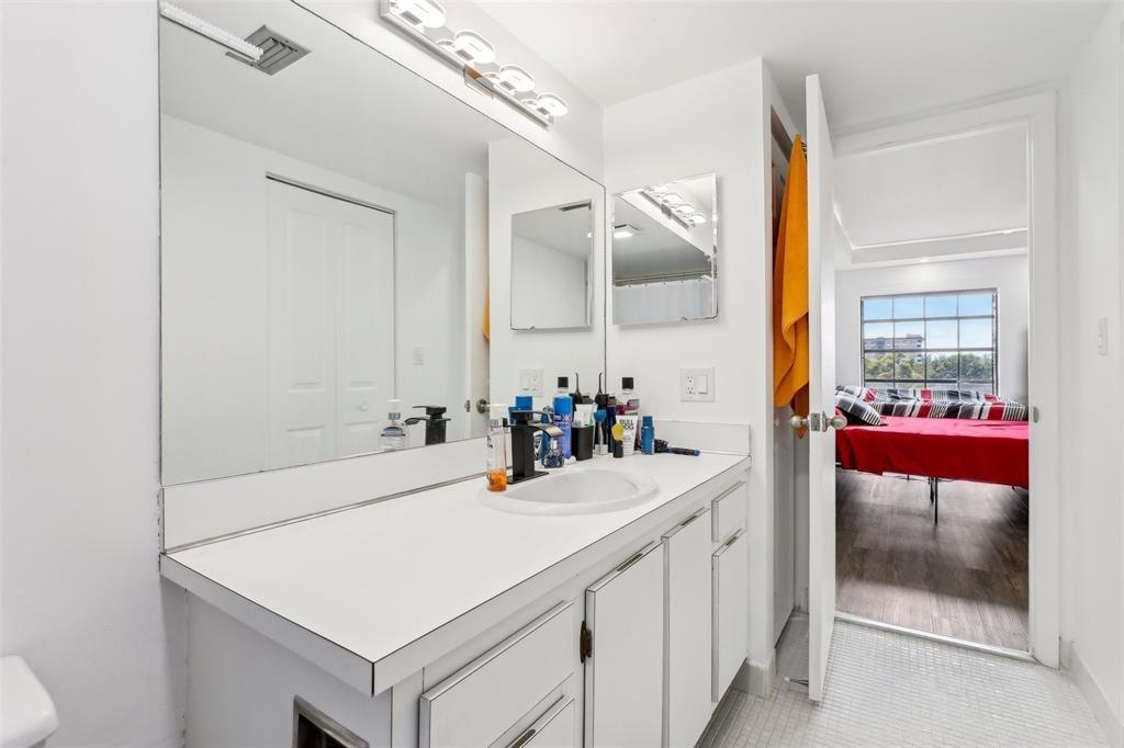 5570 Northwest 44th Street, Unit 510A Lauderhill, FL 33319 - Photo 15 of 25 a bathroom with a sink and a mirror