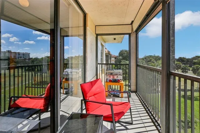 a view of a balcony with chair and wooden floor