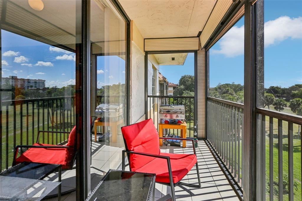5570 Northwest 44th Street, Unit 510A Lauderhill, FL 33319 - Photo 2 of 25 a view of a balcony with chair and wooden floor