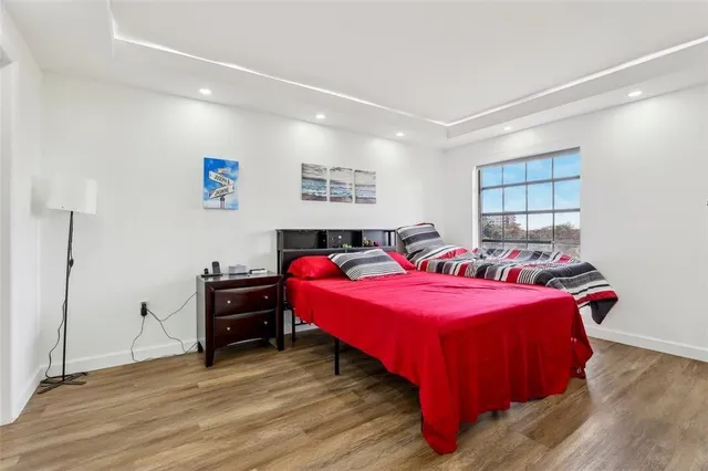 a bedroom with furniture and wooden floor