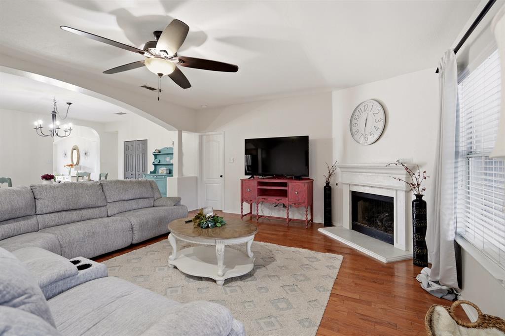 1213 Hampton Drive Forney, TX 75126 - Photo 13 of 27 a living room with furniture a fireplace and a flat screen tv