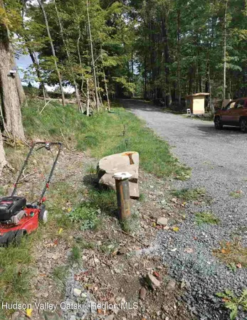 a backyard of a house with table and chairs