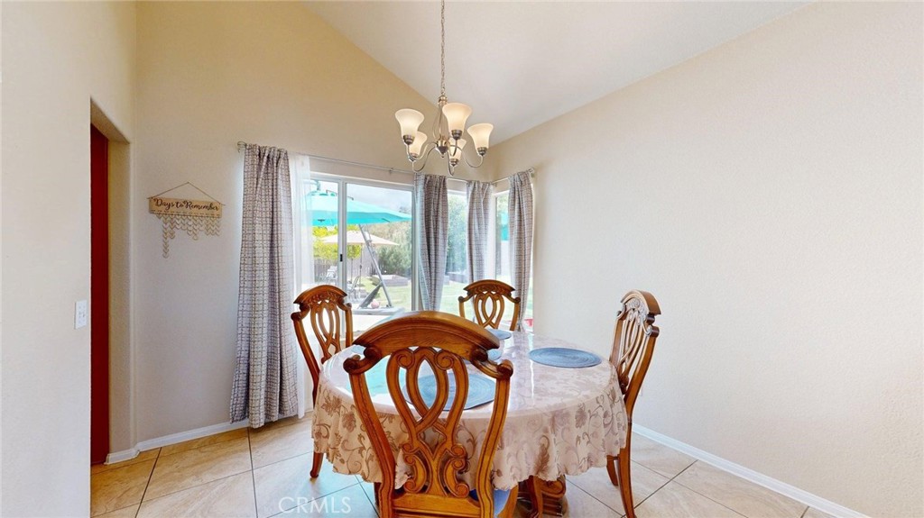 794 Banyonwood Drive Oceanside, CA 92057 - Photo 17 of 62 a view of a dining room with furniture a chandelier and a window